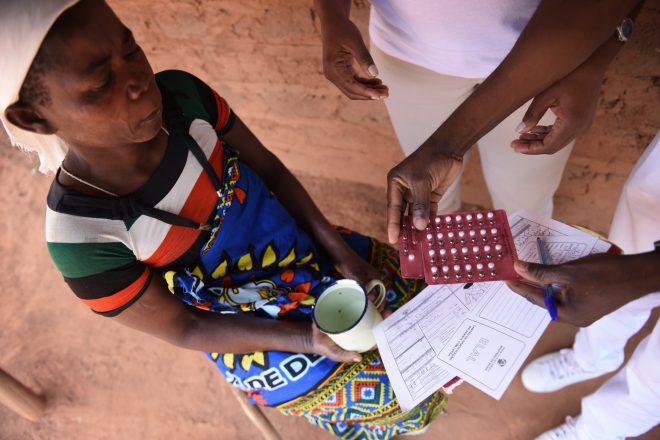 Woman in Mozambique receives leprosy treatement pills