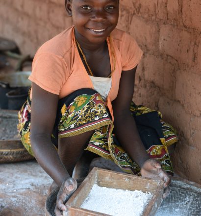 A woman sifts cassava flour