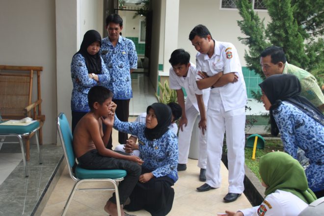 Leprosy medical staff checks Riduan from Indonesia on symptoms of leprosy