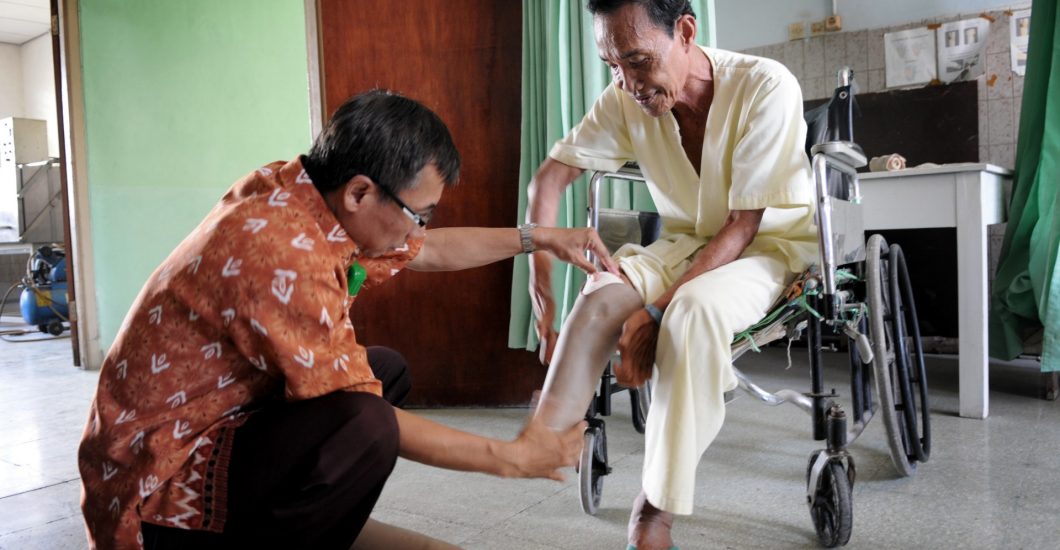 Person affected by leprosy receives a leg prosthese in order to be able to walk