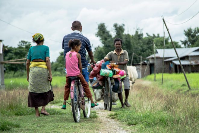 Person affected by leprosy Gobal on the bike with his daughter