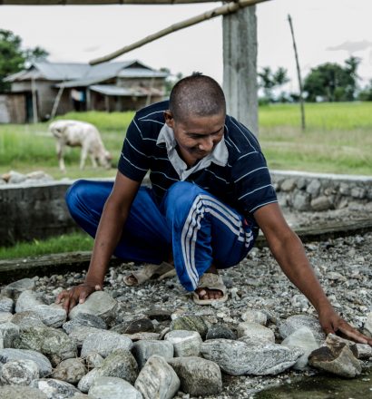 Person affected by leprosy Gobal working around the house