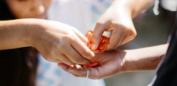 Srijana Adhikari provides a leprosy patient with medicine                