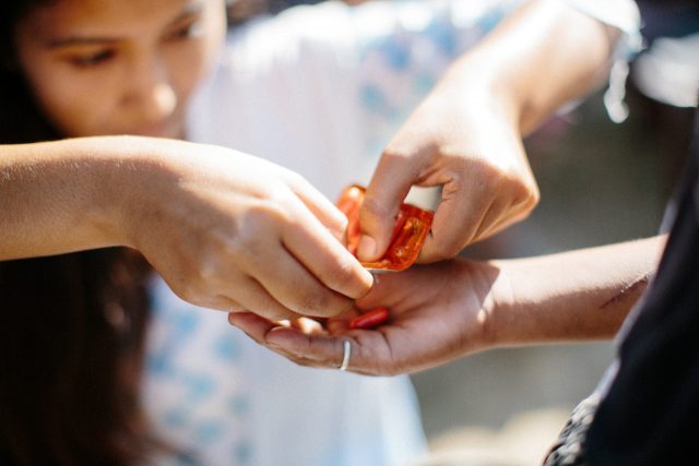 Srijana Adhikari provides a leprosy patient with medicine